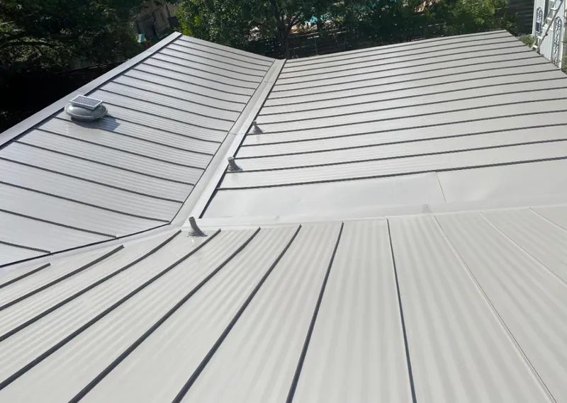 Solar attic fan installed on a metal roof for Roof Ventilation in St. Louis